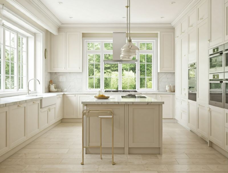 A spacious, bright porcelain kitchen with high ceilings, large windows overlooking a garden, modern appliances and cabinets, and a central island with a breakfast bar.