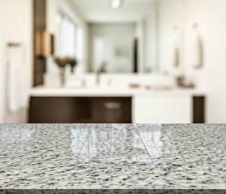 Close-up of a sleek granite countertop in a contemporary bathroom.