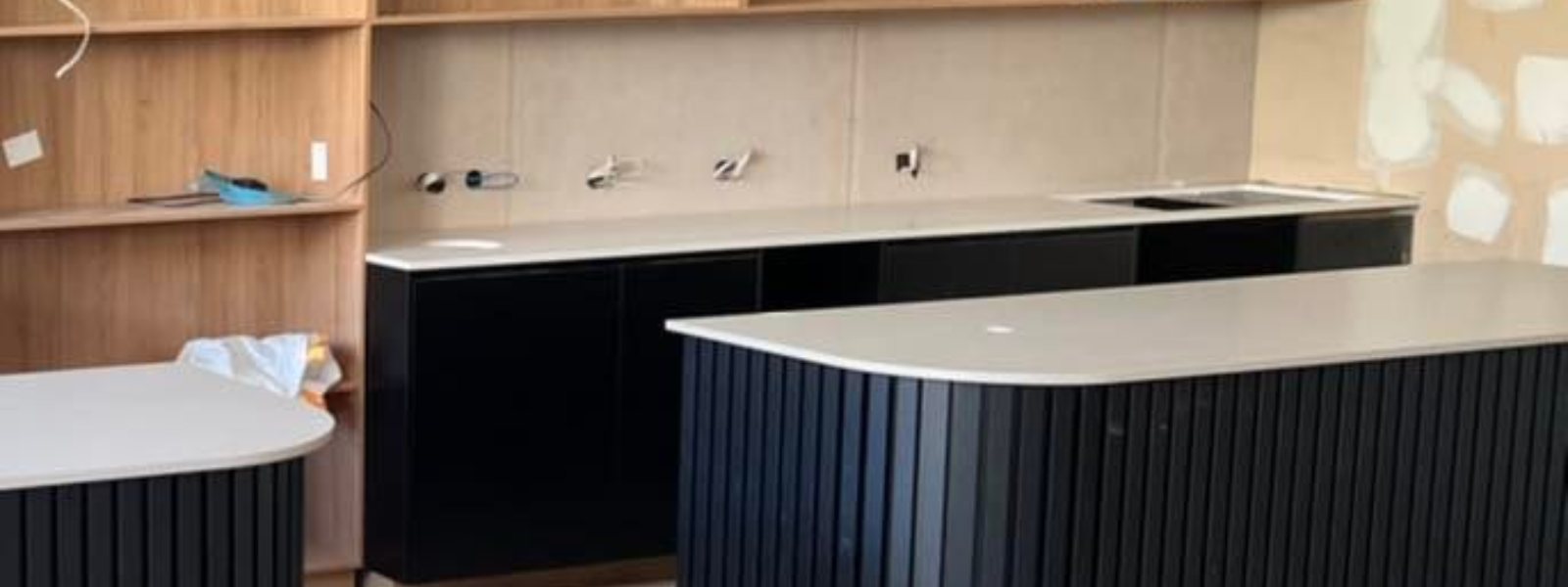 Modern kitchen with newly cleaned quartz stone countertops and black cabinetry