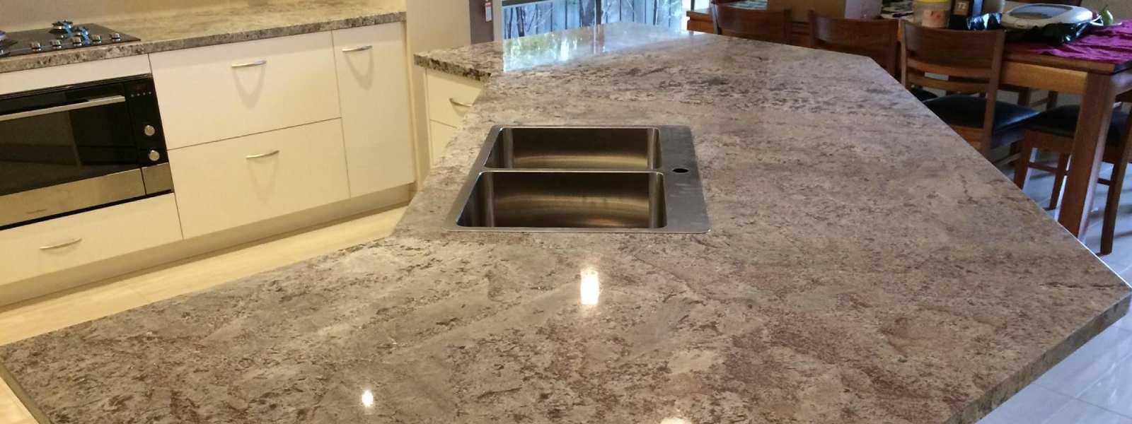 Grey granite kitchen countertop with a double sink