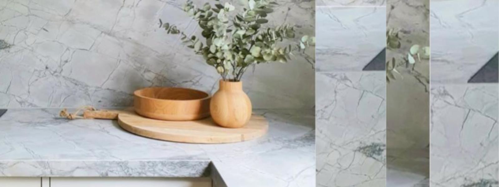 Super White Dolomite kitchen countertop with a wooden bowl and vase with greenery.