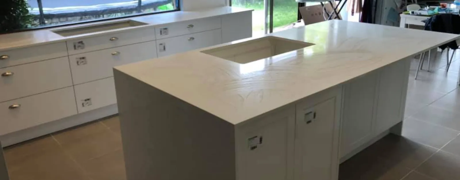 Spacious modern kitchen featuring a large white Kalala Bianco YDL stone benchtop with an integrated sink cutout