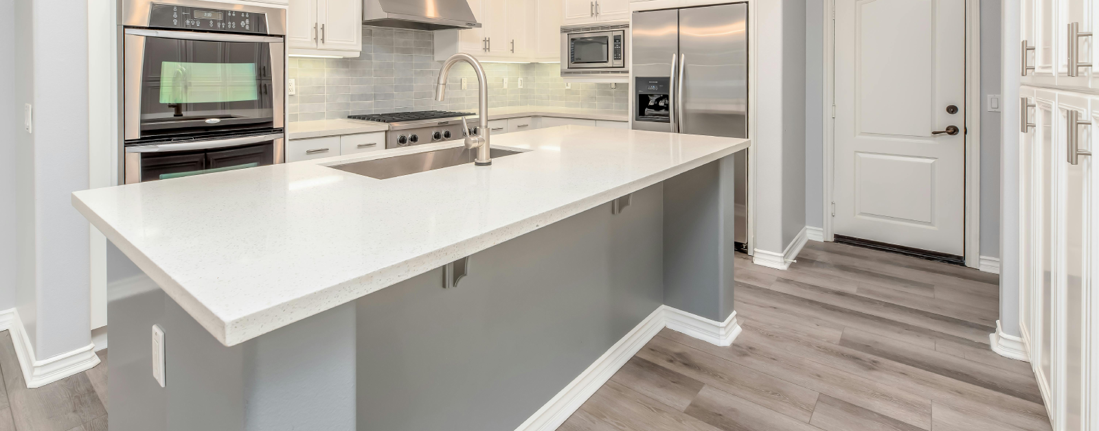 Elegant kitchen with a spacious white quartz benchtop island