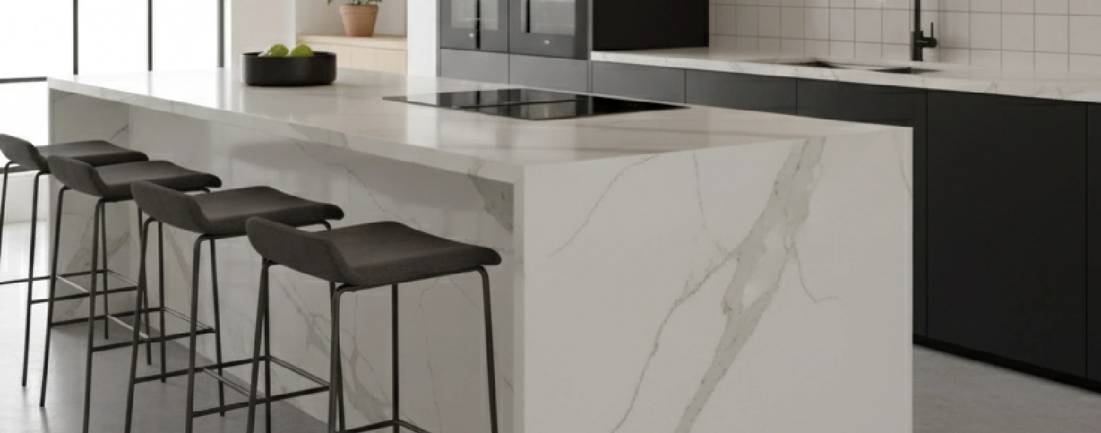 Kitchen featuring a Lavistone countertop waterfall island and black base cabinets