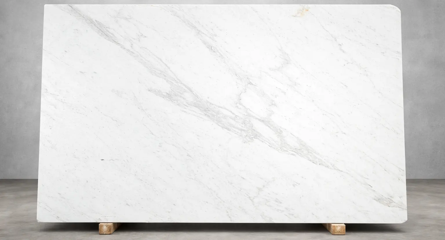 Calacatta marble slab with soft gray veining displayed in a modern stone showroom